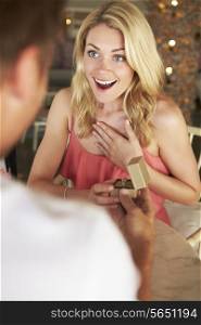 Man Proposing To Woman In Restaurant
