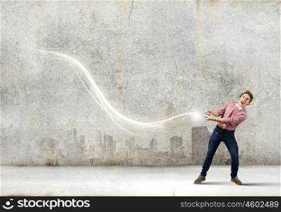 Man pull light loop. Young guy in casual pulling loop of light