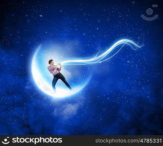 Man pulling moon. Young man in casual catching moon with rope