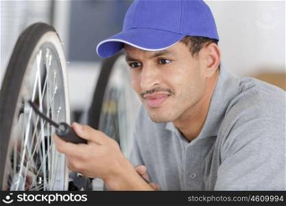man pumping a bike wheel