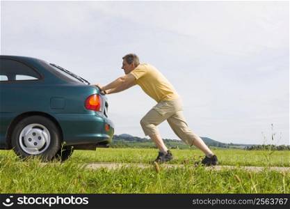 Man pushing a car with empty gas tank