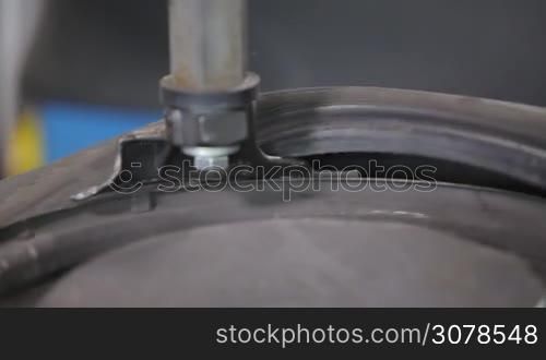 Man put on tire on car wheel by special tool, closeup view