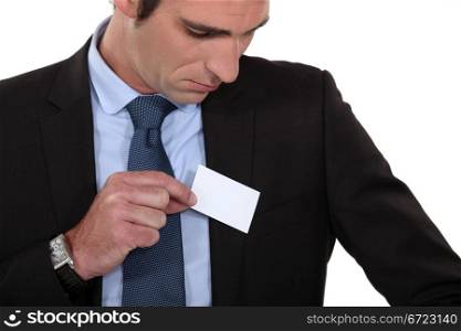 Man putting a business card into his pocket