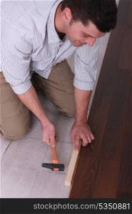 Man putting in new flooring