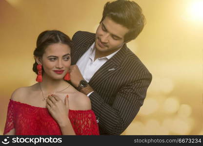 Man putting necklace on wife