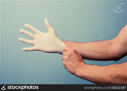 Man putting on a latex glove
