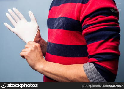 Man putting on a rubber glove