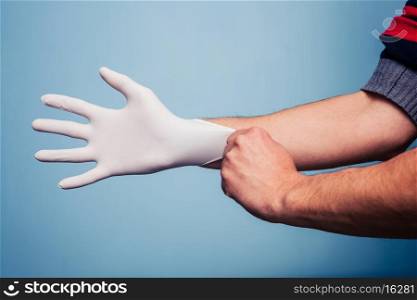 Man putting on rubber glove