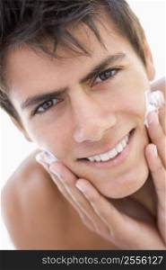 Man putting on shaving cream smiling