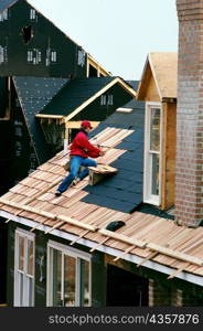 Man putting roof on new home in Mongomery County , Maryland