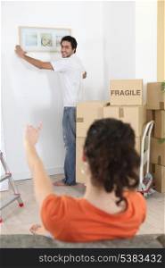 Man putting up a picture frame