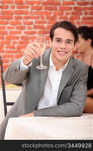 Man raising a glass of champagne