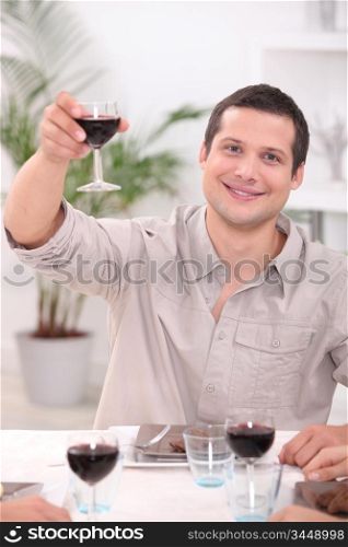 Man raising his glass for a toast