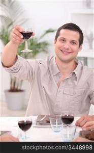 Man raising his glass for a toast