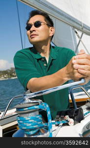 Man Raising Sail on Sailboat