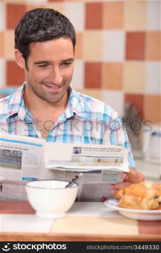 Man reading a journal over breakfast