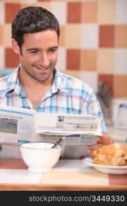 Man reading a journal over breakfast