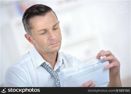 Man reading a letter he&rsquo;s received
