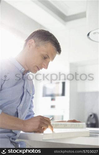 Man reading book at home