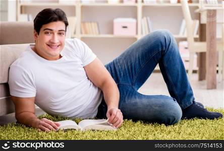 Man reading book at home on floor. The man reading book at home on floor