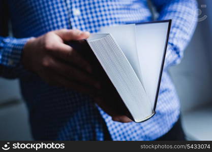 Man reading. Book in his hands.