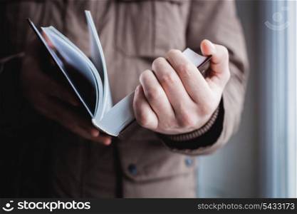 Man reading. Book in his hands.