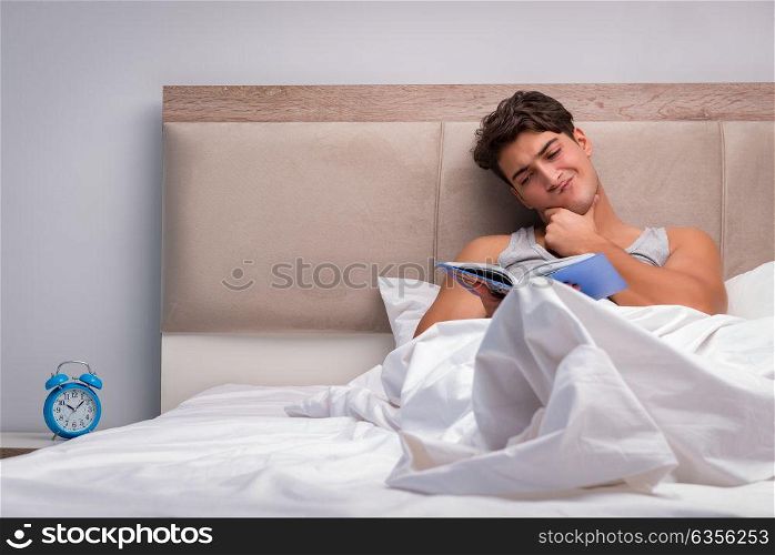 Man reading book in the bed