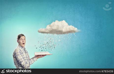 Man reading book. Young man with book in hands and cloud concept