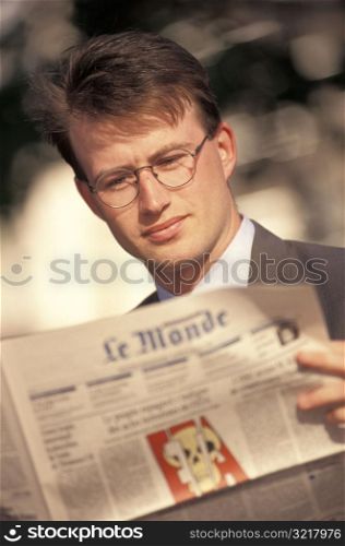 Man Reading French Newspaper