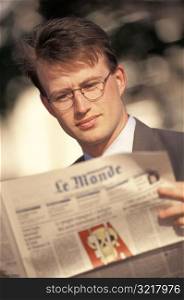 Man Reading French Newspaper
