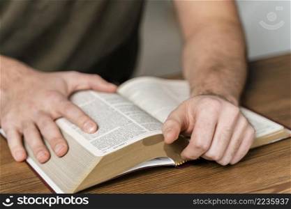 man reading from bible table