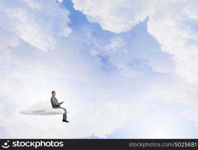 Man reading in isolation. Young businessman sitting on cloud and reading book