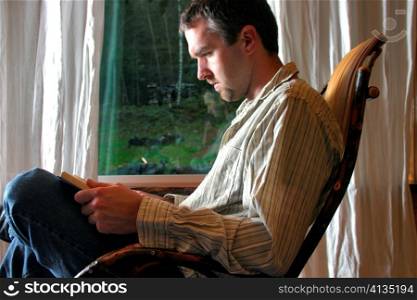 Man Reading in Rocking Chair