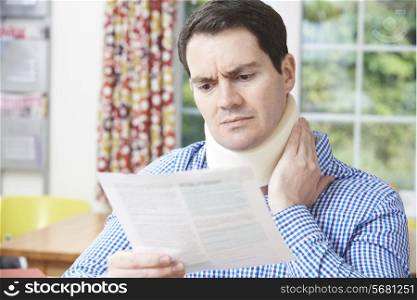 Man Reading Letter After Receiving Neck Injury