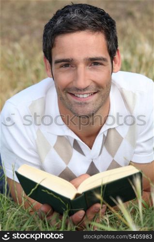 Man reading on the grass