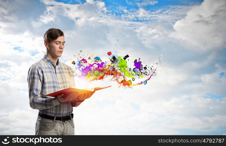 Man reading red book. Young student guy with opened book in hands