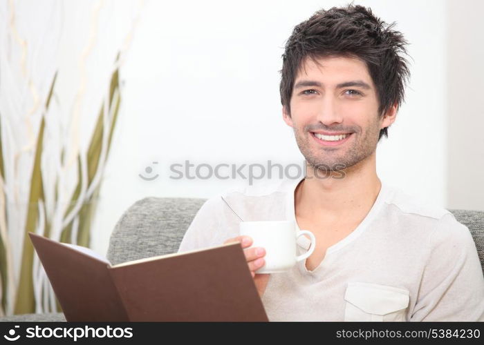 Man reading with coffee in hand