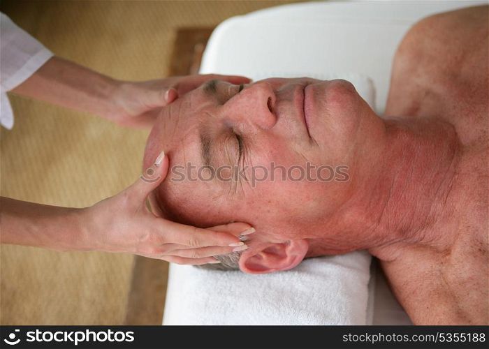 Man receiving a head massage