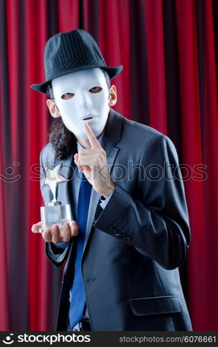Man receiving award in mask
