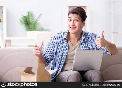 Man receiving parcel at home