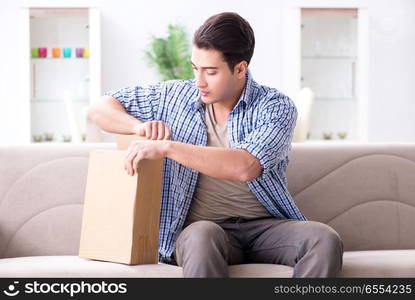 Man receiving parcel at home