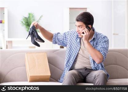 Man receiving wrong parcel with female woman shoes