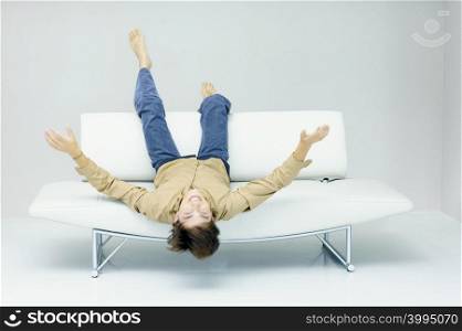 Man reclining on modern sofa