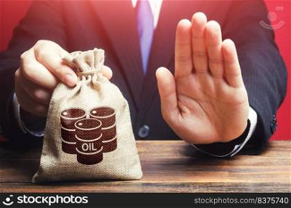 Man refuses to give a bag with oil barrel icon. Refusal to purchase, lack of space for savings and storage. Rejection of offers and breaking of agreements between oil producers. loss making production