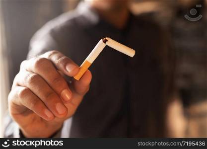 Man refusing cigarettes concept for quitting smoking and healthy lifestyle dark background. or No smoking campaign Concept.