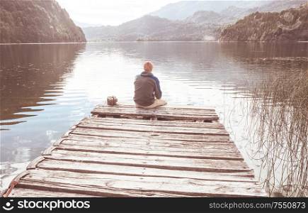 Man relaxing at beautiful mountains lake.