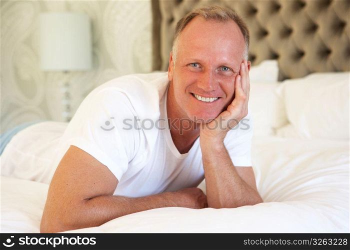Man Relaxing In Bedroom
