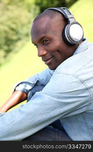 Man relaxing in garden with headphones on