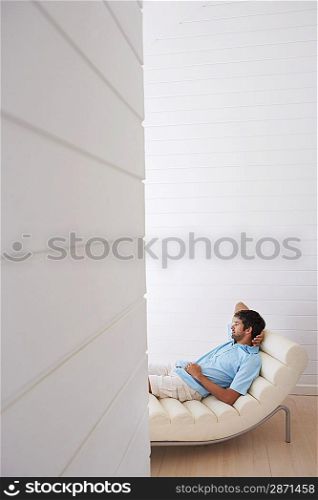 Man Relaxing on Chaise Longue