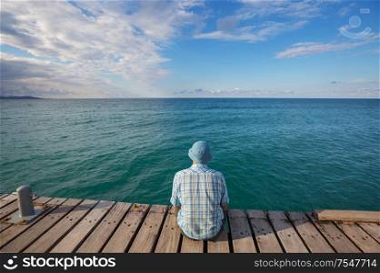 Man relaxing on sea pier